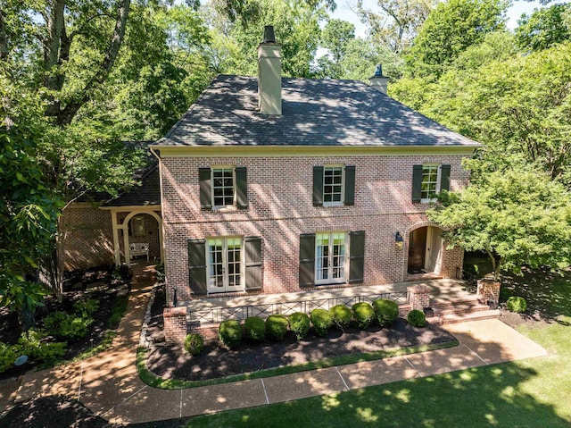 7726 Chapel Creek Pkwy N, Memphis, TN 38016 - view of front of home featuring french doors, a chimney, brick siding, and a patio