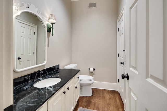 7726 Chapel Creek Pkwy N, Memphis, TN 38016 - bathroom with vanity, baseboards, wood finished floors, and toilet