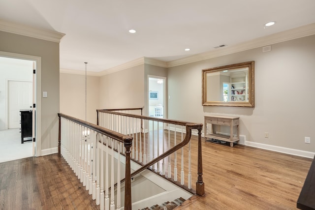 7726 Chapel Creek Pkwy N, Memphis, TN 38016 - hallway featuring an upstairs landing, wood finished floors, crown molding, baseboards, and recessed lighting