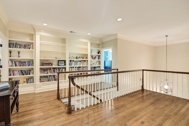 7726 Chapel Creek Pkwy N, Memphis, TN 38016 - corridor with wood finished floors, ornamental molding, recessed lighting, built in features, and an upstairs landing