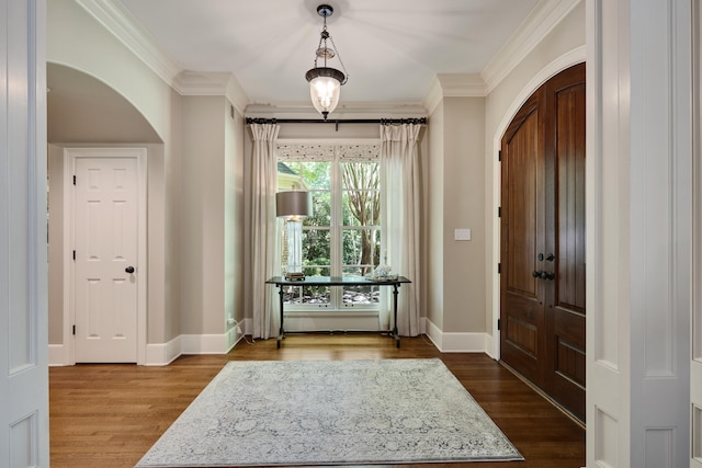 7726 Chapel Creek Pkwy N, Memphis, TN 38016 - entrance foyer featuring crown molding, baseboards, arched walkways, and dark wood finished floors