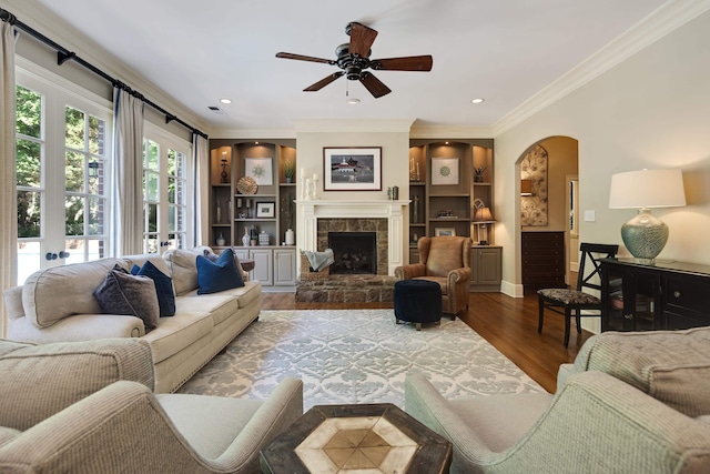 7726 Chapel Creek Pkwy N, Memphis, TN 38016 - living area with wood finished floors, crown molding, a ceiling fan, arched walkways, and a fireplace