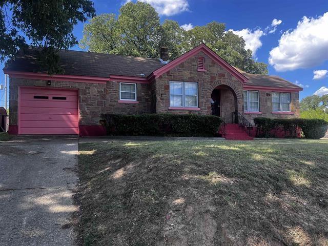 760 E Mckellar Ave, Memphis, TN 38106 - ranch-style home with stone siding, an attached garage, driveway, and a front yard