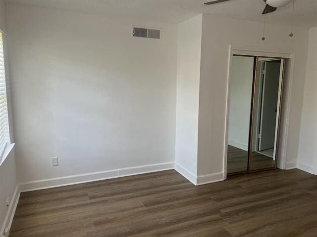 760 E Mckellar Ave, Memphis, TN 38106 - unfurnished bedroom featuring dark wood-type flooring, a closet, and baseboards