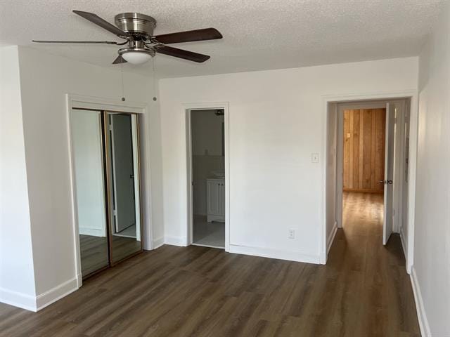 760 E Mckellar Ave, Memphis, TN 38106 - unfurnished bedroom with dark wood-type flooring, baseboards, a closet, a textured ceiling, and ensuite bath