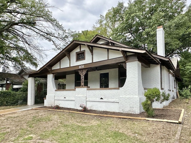 1151 Tanglewood St, Memphis, TN 38114 - view of front facade featuring brick siding, a chimney, and a porch