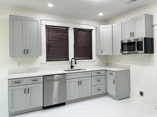 1151 Tanglewood St, Memphis, TN 38114 - kitchen featuring appliances with stainless steel finishes, a sink, gray cabinets, ornamental molding, and recessed lighting