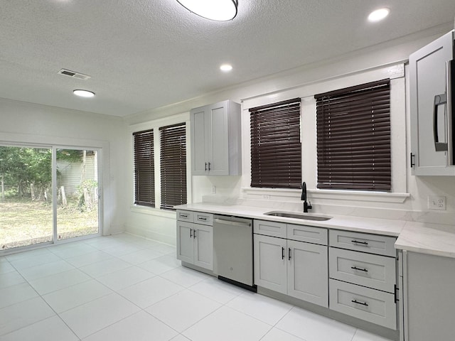 1151 Tanglewood St, Memphis, TN 38114 - kitchen featuring dishwasher, a sink, gray cabinets, a textured ceiling, and light tile patterned floors