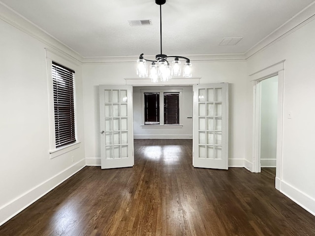 1151 Tanglewood St, Memphis, TN 38114 - unfurnished dining area with french doors, wood finished floors, a chandelier, ornamental molding, and baseboards