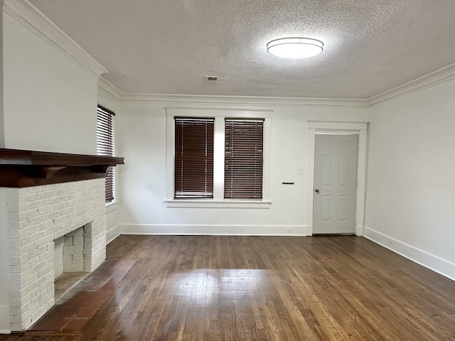 1151 Tanglewood St, Memphis, TN 38114 - unfurnished living room with wood finished floors, a textured ceiling, baseboards, ornamental molding, and a fireplace