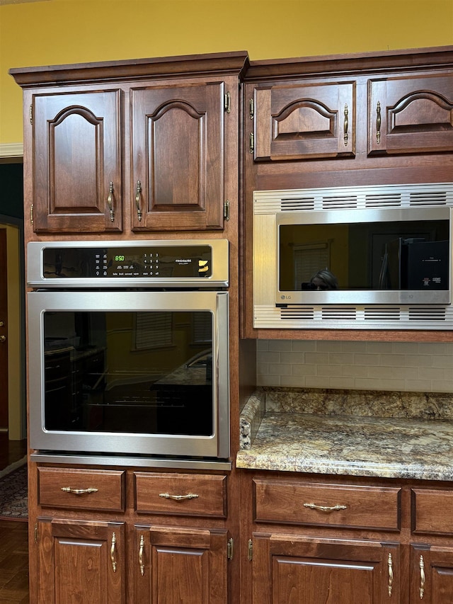 917 Valleyview Ln, Collierville, TN 38017 - kitchen view of stainless steel appliances, backsplash, and dark brown cabinetry