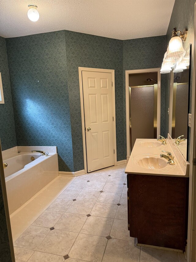 917 Valleyview Ln, Collierville, TN 38017 - bathroom featuring a garden tub, double vanity, a shower stall, a textured ceiling, and tile patterned floors