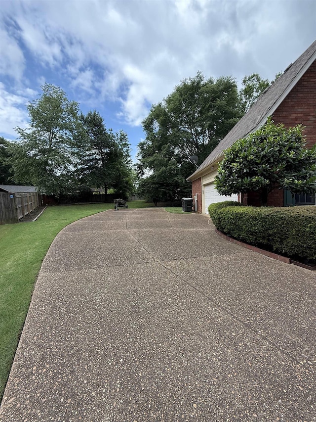 917 Valleyview Ln, Collierville, TN 38017 - view of yard with a garage, central air condition unit, and driveway