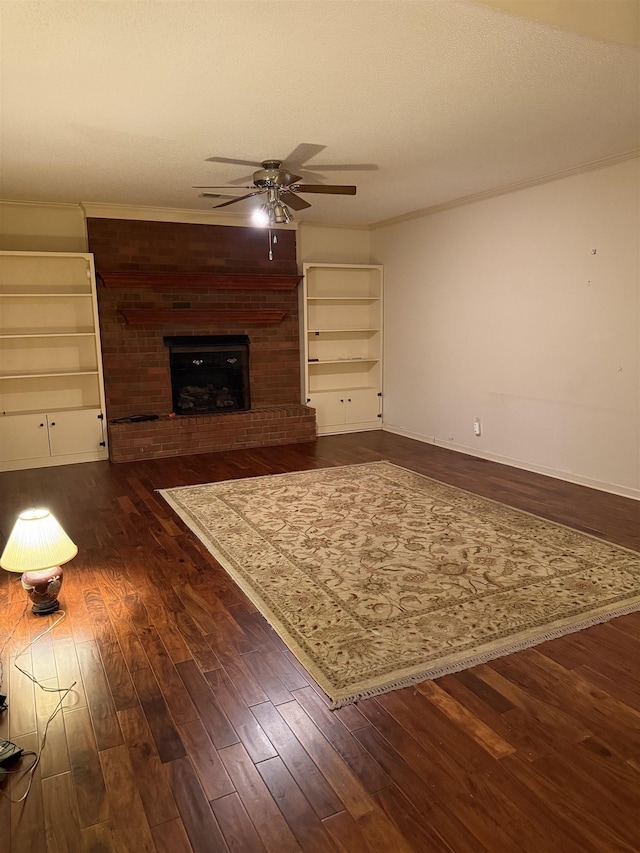 917 Valleyview Ln, Collierville, TN 38017 - living area featuring a ceiling fan, dark wood-type flooring, a brick fireplace, crown molding, and baseboards