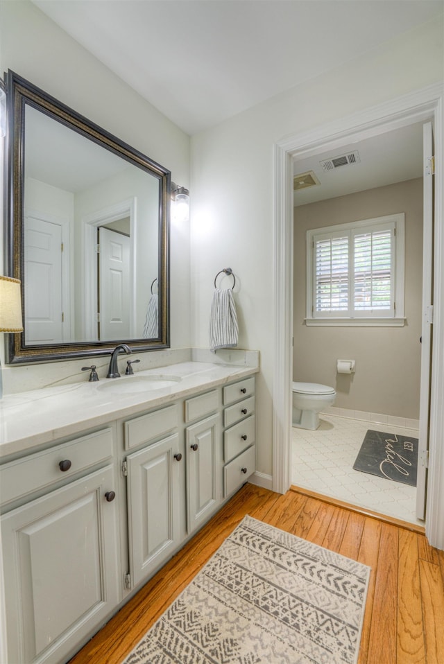 7352 Magnolia Ridge Dr, Germantown, TN 38138 - bathroom with vanity, toilet, wood finished floors, and baseboards