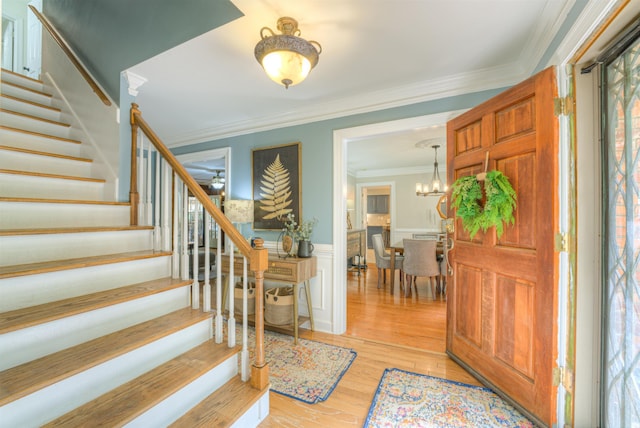 7352 Magnolia Ridge Dr, Germantown, TN 38138 - foyer with stairway, crown molding, wainscoting, light wood-style floors, and a ceiling fan