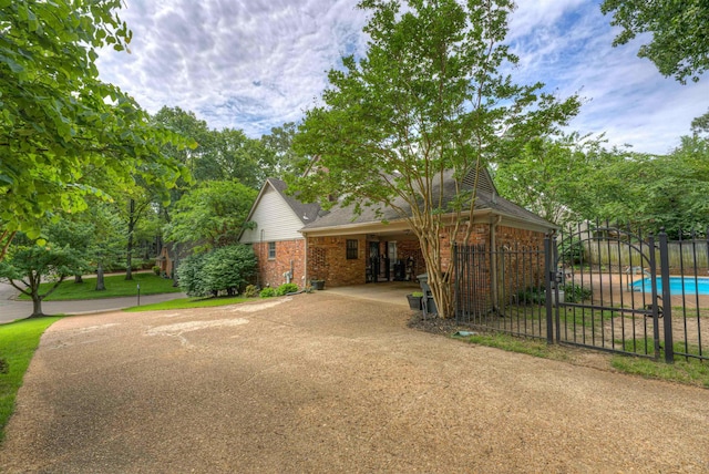 7352 Magnolia Ridge Dr, Germantown, TN 38138 - view of front of property with concrete driveway, brick siding, a gate, and a carport