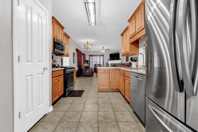 5578 Southern Winds Dr, Arlington, TN 38002 - kitchen with appliances with stainless steel finishes, open floor plan, light countertops, a chandelier, and light tile patterned floors