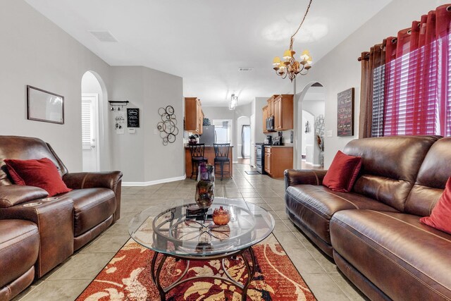 5578 Southern Winds Dr, Arlington, TN 38002 - living area with arched walkways, a chandelier, light tile patterned floors, and baseboards
