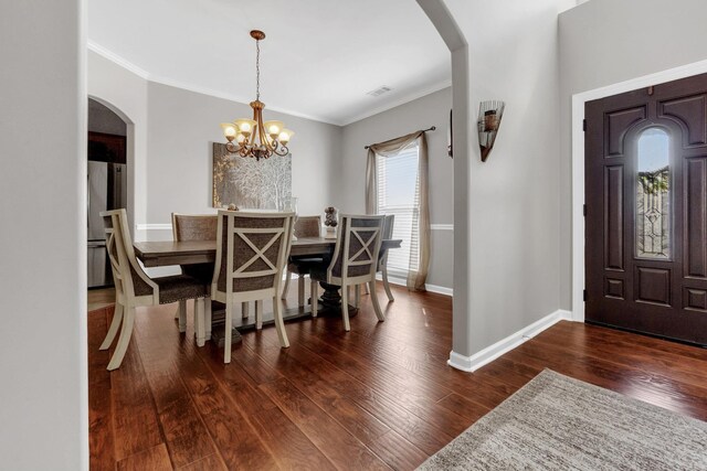 5578 Southern Winds Dr, Arlington, TN 38002 - dining space featuring arched walkways, dark wood-type flooring, baseboards, ornamental molding, and a chandelier