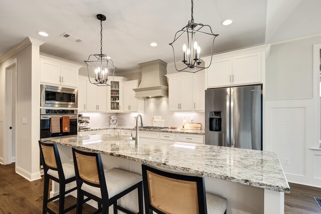 125 Magnolia Park Dr, Rossville, TN 38066 - kitchen with appliances with stainless steel finishes, a chandelier, custom range hood, white cabinetry, and recessed lighting