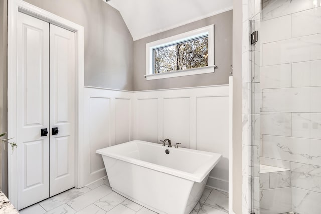 125 Magnolia Park Dr, Rossville, TN 38066 - full bath with marble look tiles, a soaking tub, a decorative wall, and a wainscoted wall