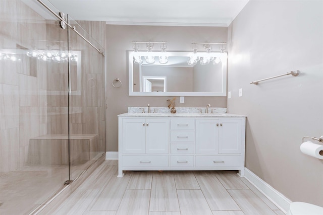 470 N Highland St, Memphis, TN 38122 - bathroom featuring double vanity, a shower stall, baseboards, and ornamental molding