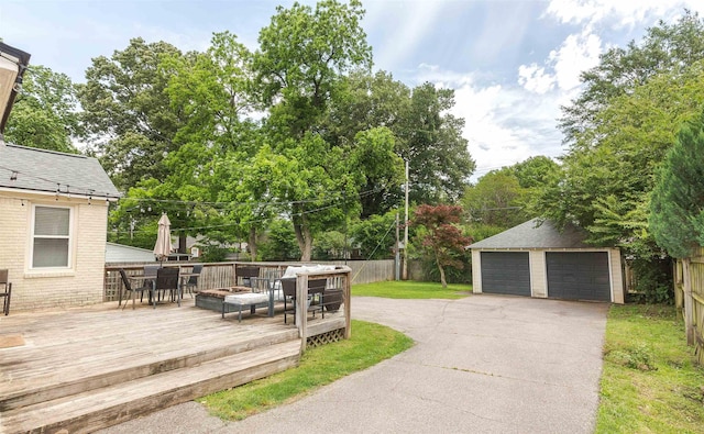 470 N Highland St, Memphis, TN 38122 - deck featuring outdoor dining space, a detached garage, and an outdoor structure