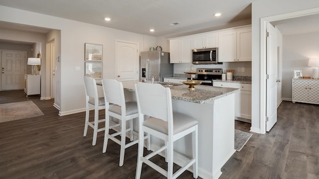 4494 Royster Creek Dr, Millington, TN 38053 - kitchen featuring stainless steel appliances, a center island with sink, white cabinets, baseboards, and recessed lighting