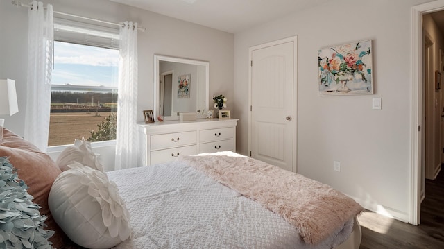 4494 Royster Creek Dr, Millington, TN 38053 - bedroom featuring multiple windows, dark wood-type flooring, and baseboards