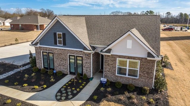 4494 Royster Creek Dr, Millington, TN 38053 - craftsman-style house with brick siding, french doors, and a shingled roof