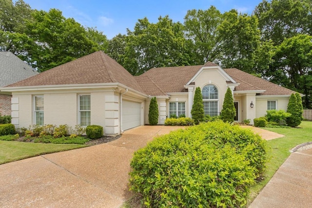 1772 Richman Ln, Germantown, TN 38139 - view of front of home featuring a garage, concrete driveway, roof with shingles, and a front yard