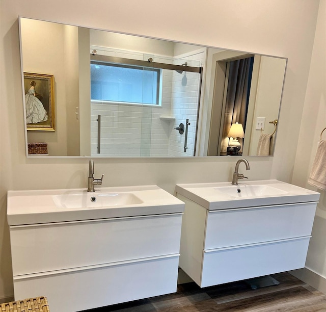 5510 Rams Horn Dr, Millington, TN 38053 - bathroom with vanity, tiled shower, and wood finished floors