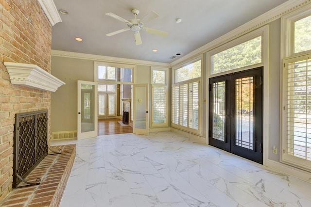 9200 Forest Hill Ln, Germantown, TN 38139 - foyer with french doors, a brick fireplace, ornamental molding, marble look tiles, and baseboards