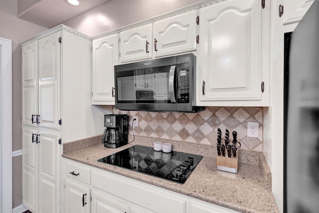 8955 Clair Douwie Cv, Bartlett, TN 38133 - kitchen featuring black appliances, backsplash, and white cabinets