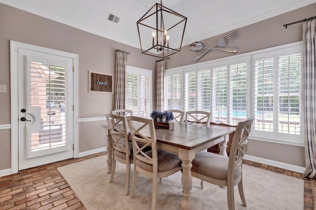 8955 Clair Douwie Cv, Bartlett, TN 38133 - dining space with crown molding, a chandelier, baseboards, and brick floors