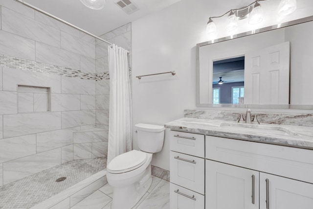 8955 Clair Douwie Cv, Bartlett, TN 38133 - bathroom featuring toilet, marble finish floors, vanity, tiled shower, and ceiling fan