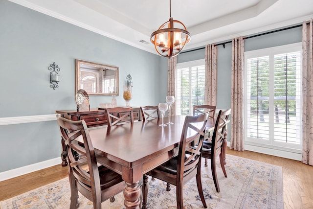 8955 Clair Douwie Cv, Bartlett, TN 38133 - dining area with a chandelier, healthy amount of natural light, light wood-type flooring, baseboards, and ornamental molding