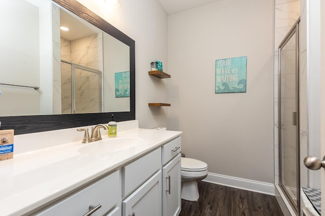 128 Loch Haven Cv S, Atoka, TN 38004 - bathroom with vanity, toilet, a stall shower, wood finished floors, and baseboards