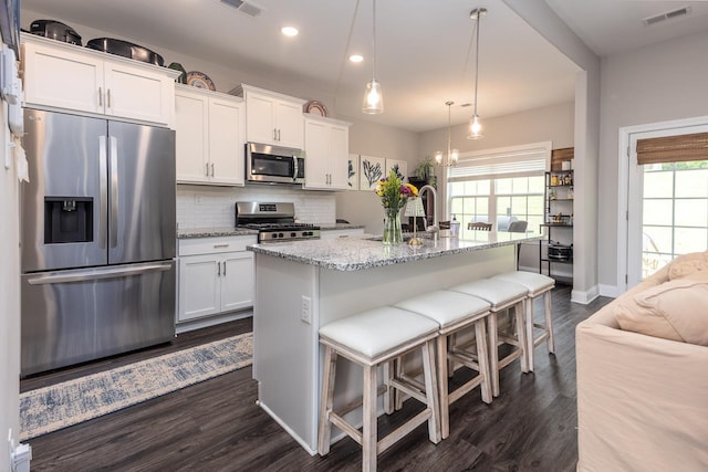 128 Loch Haven Cv S, Atoka, TN 38004 - kitchen with stainless steel appliances, dark wood-style flooring, decorative backsplash, white cabinets, and recessed lighting