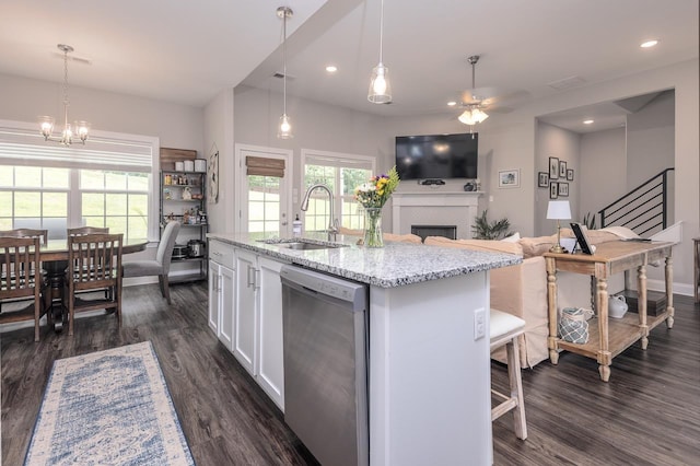 128 Loch Haven Cv S, Atoka, TN 38004 - kitchen with stainless steel dishwasher, a sink, a ceiling fan, dark wood-style flooring, and white cabinets