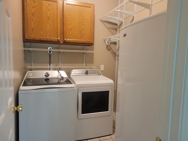 3659 Stonetrace Cir, Bartlett, TN 38135 - laundry area featuring washer and clothes dryer, cabinet space, and light tile patterned flooring