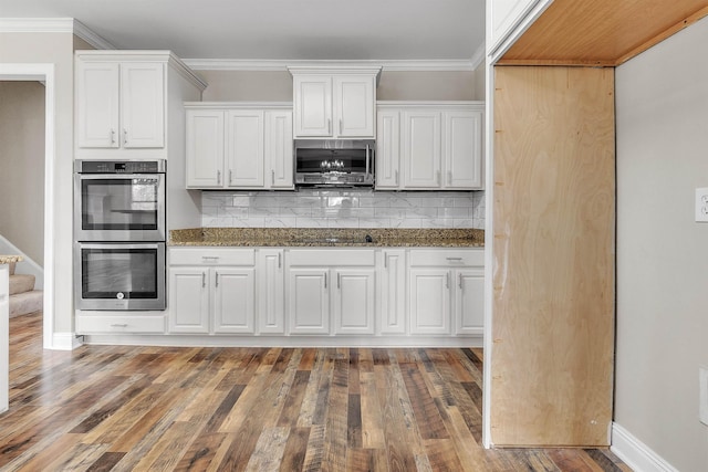8917 River Sound Dr, Cordova, TN 38016 - kitchen with stainless steel appliances, white cabinets, tasteful backsplash, wood finished floors, and stone countertops