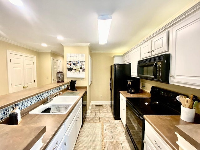 29 Frank Fwy, Iuka, MS 38852 - kitchen with black appliances, a sink, crown molding, white cabinetry, and baseboards