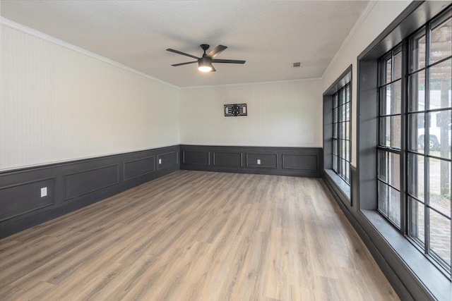 268 Tara Cv, Hernando, MS 38632 - spare room featuring ceiling fan, ornamental molding, a decorative wall, wood finished floors, and a textured ceiling