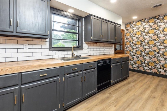 268 Tara Cv, Hernando, MS 38632 - kitchen with wooden counters, dishwasher, a sink, baseboards, and light wood finished floors