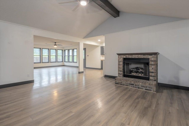 268 Tara Cv, Hernando, MS 38632 - unfurnished living room featuring ceiling fan, beam ceiling, a brick fireplace, wood finished floors, and baseboards