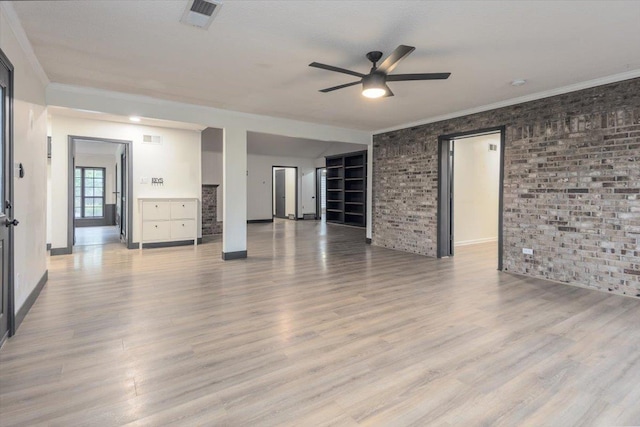 268 Tara Cv, Hernando, MS 38632 - unfurnished living room with ceiling fan, wood finished floors, ornamental molding, brick wall, and baseboards