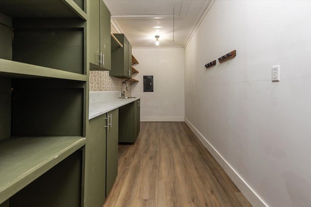 268 Tara Cv, Hernando, MS 38632 - kitchen featuring wood finished floors, a sink, light countertops, baseboards, and green cabinets