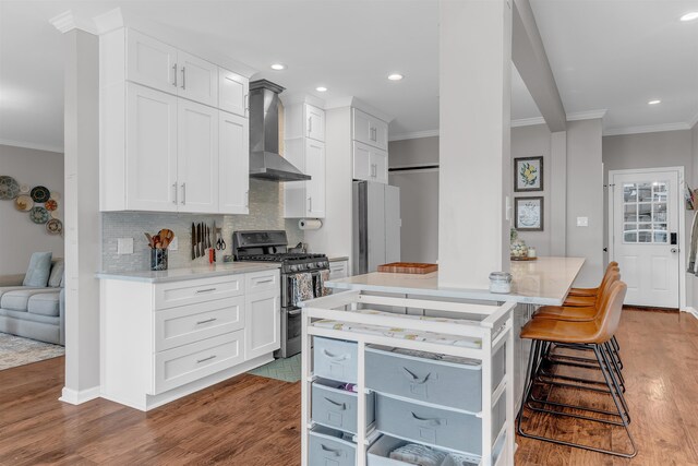 12262 Kathleen Cv, Arlington, TN 38002 - kitchen with wall chimney exhaust hood, stainless steel appliances, crown molding, light wood-style flooring, and recessed lighting
